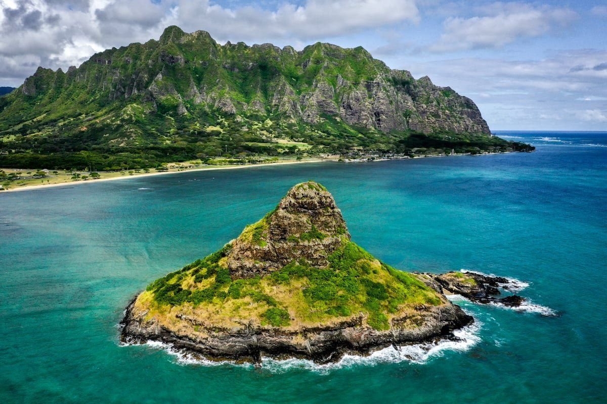 Mokoliʻi islet rising from turquoise water off Oahu's green windward coast